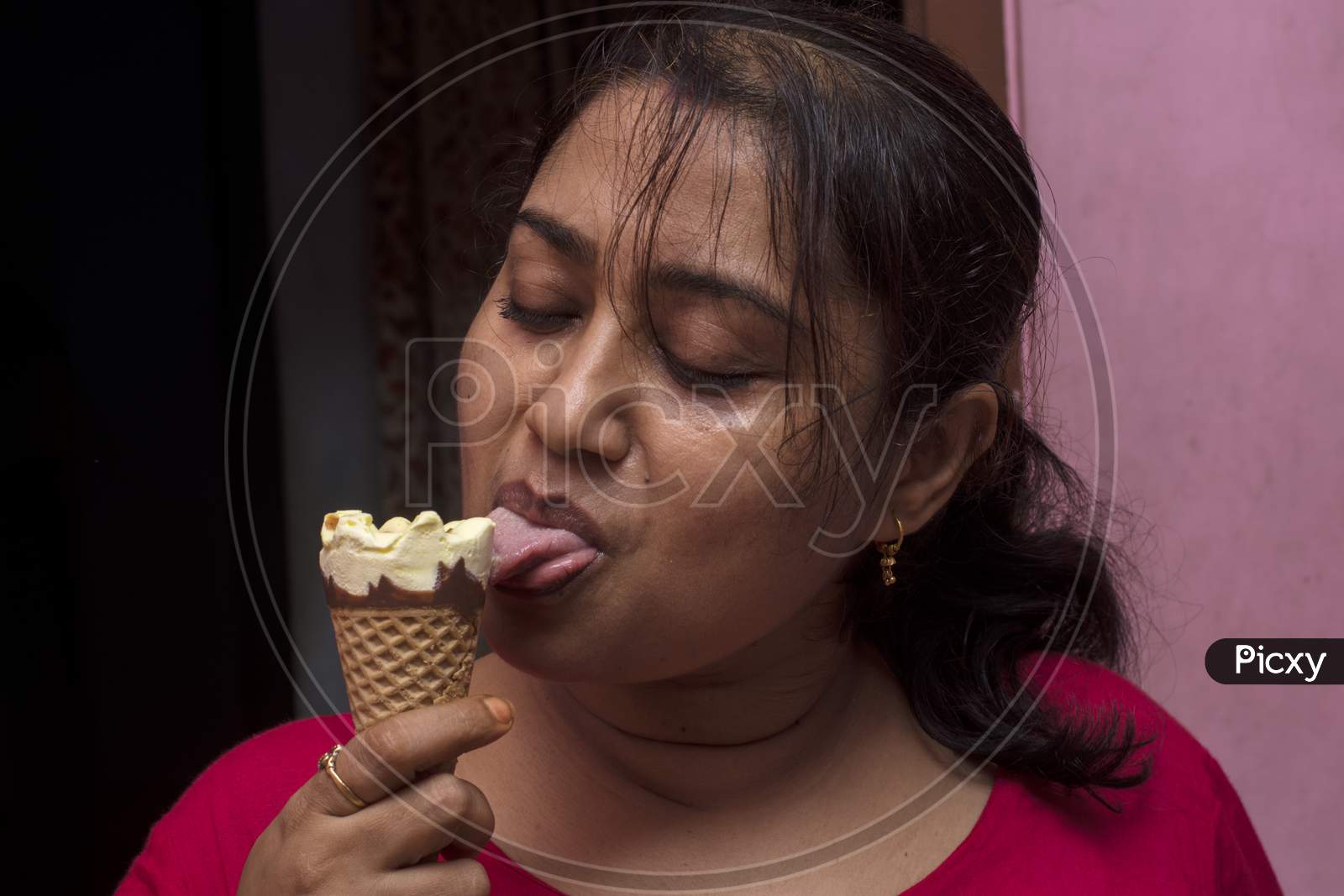 A Young Lady Enjoying Cone Ice Cream. Selective Focus.