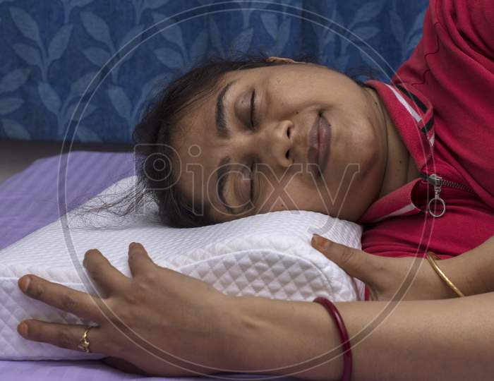 A Young Lady Sleeping On A Orthopedic Memory Foam Pillow With Comfort.A Young Lady Sleeping On A Orthopedic Memory Foam Pillow With Comfort.