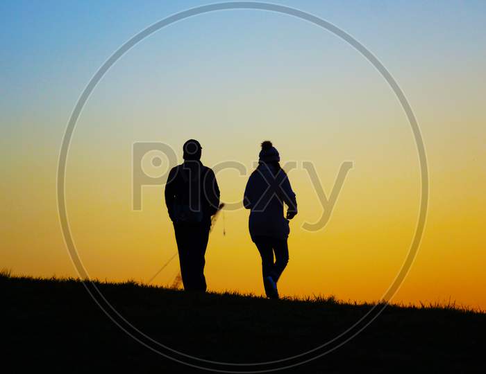 Two People To Walk The Evening Of The Hill