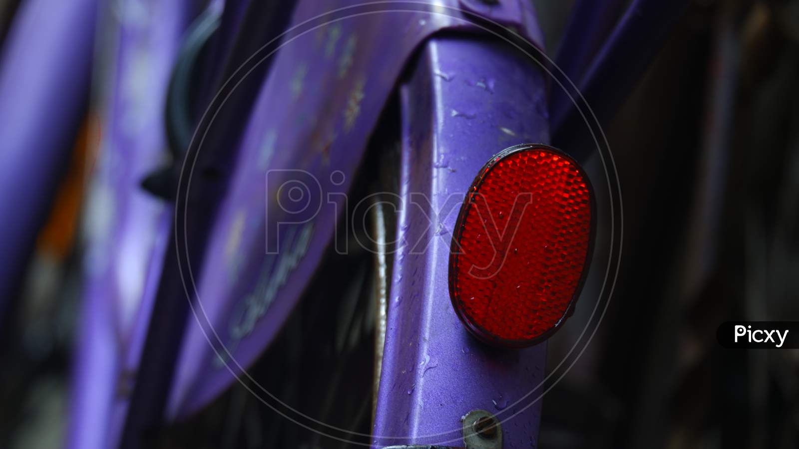 Close Up Image Of Red Safety Reflector Or Red Back Light Of Indian Bicycle.