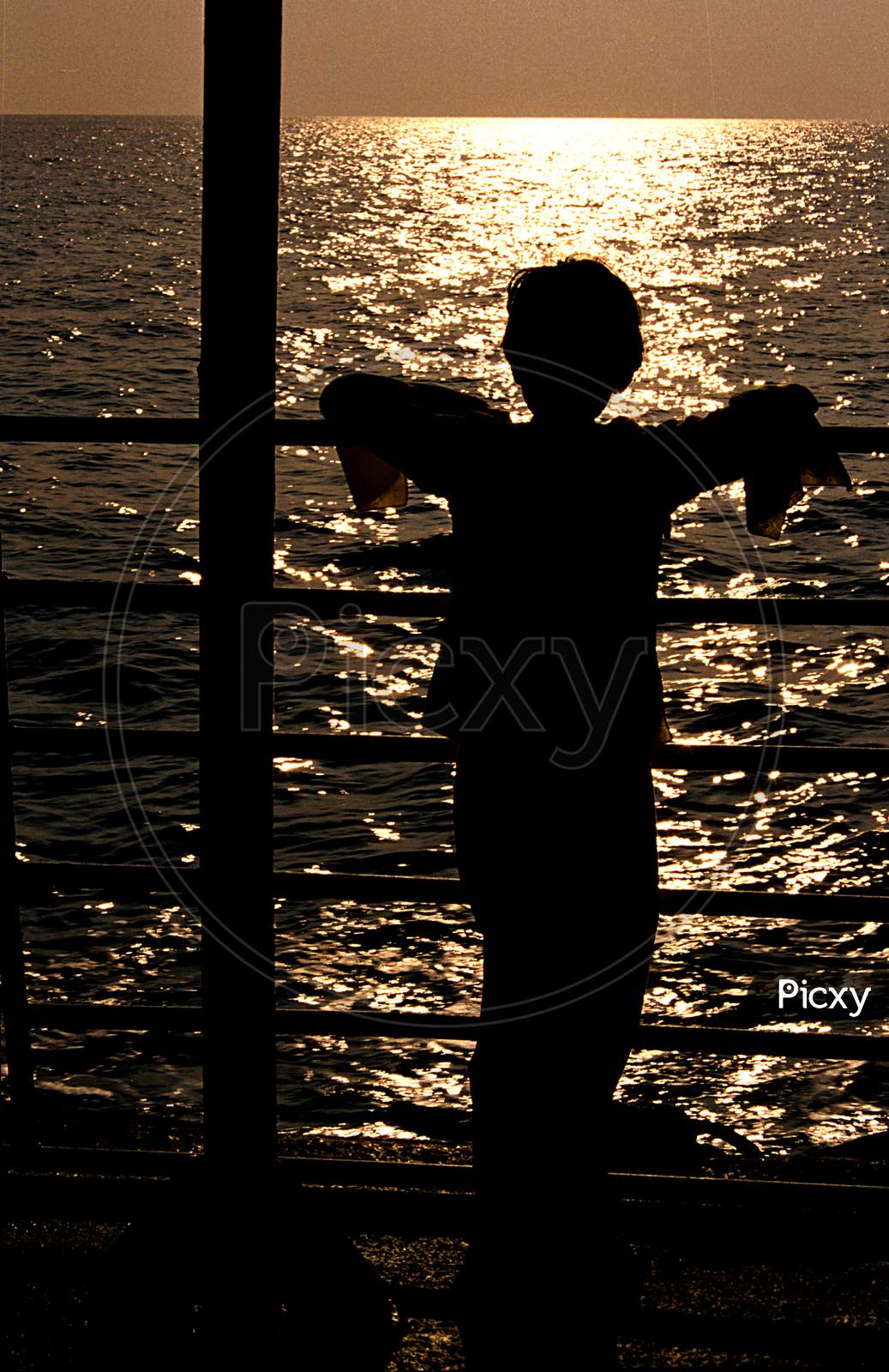 Girl Watching Sunset From Ship Deck