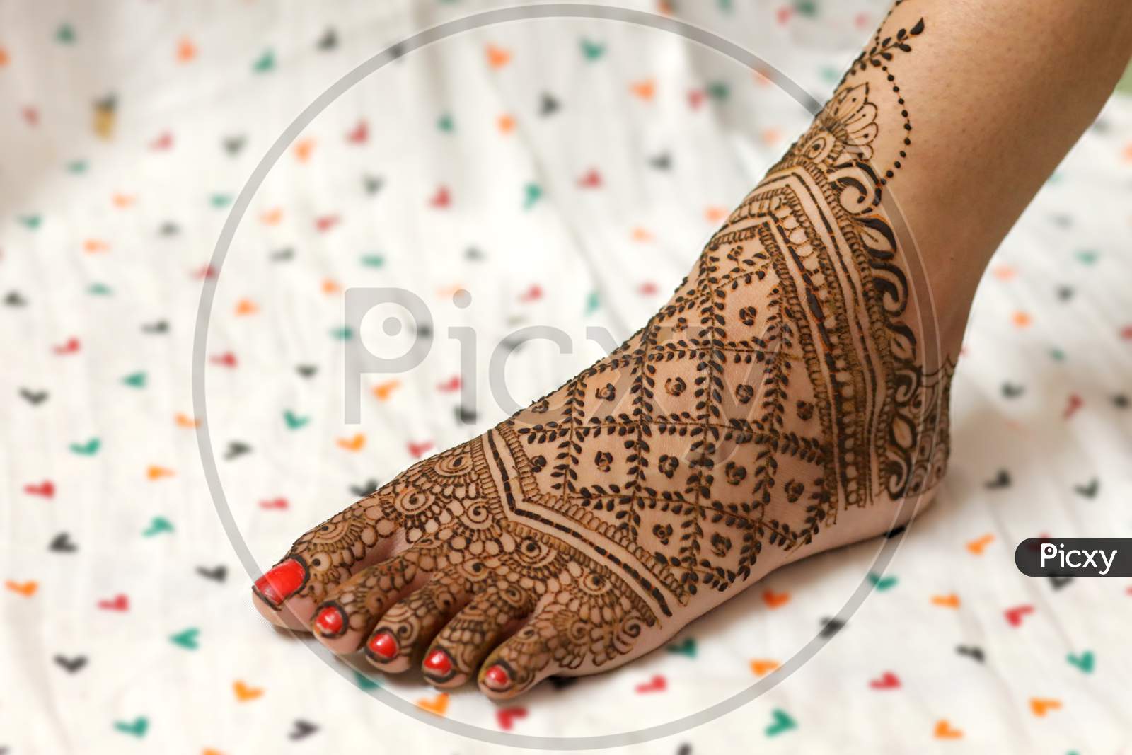 Image of Beautiful henna or mehendi decoration on a hindu bride's hand &  Feet | Isolated hand & feet with diyaRed & Yellow Background-WC050520-Picxy