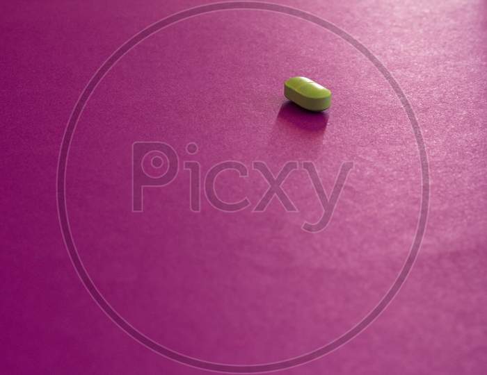 Small Pill On A Neutral Violet Background. Free Space To Write.