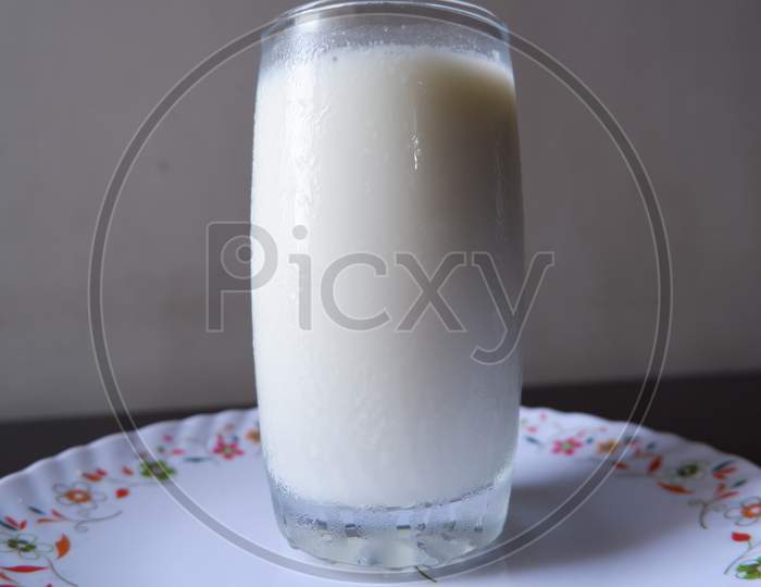 Glass of Milk on white printed plate