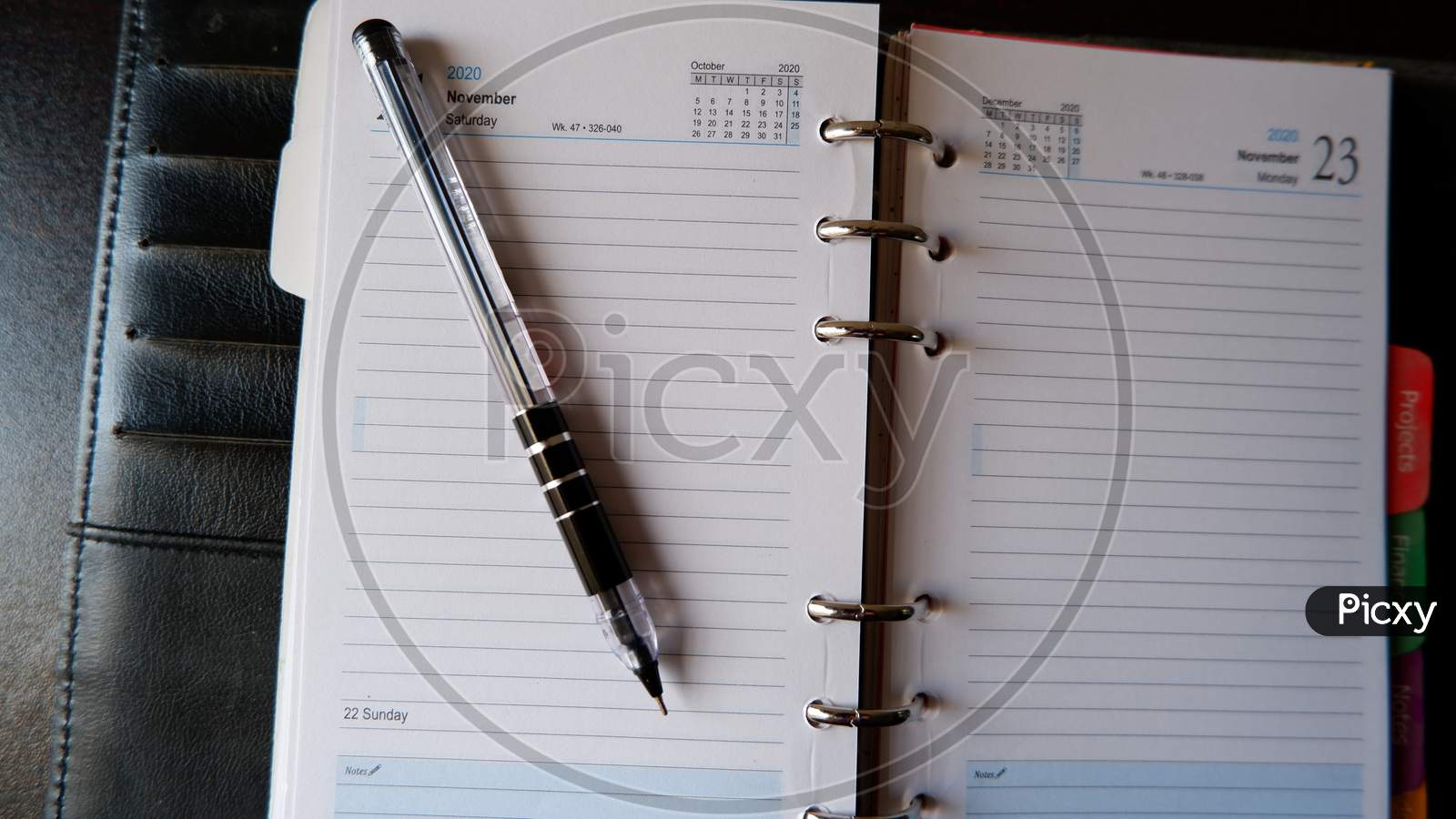 Top view of open pen placed on open diary