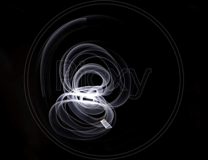 Unique, Long Exposure, White Led Light Painting Photograph Of Abstract Pattern On Black Background.