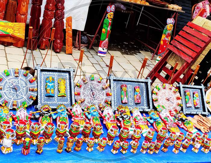 Colorful wooden and burnt soil products being displayed on the street shop in Kolkata during handcraft festival. Selective focus.
