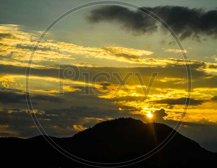 Image Of The Sun Sinking Into The Mountains