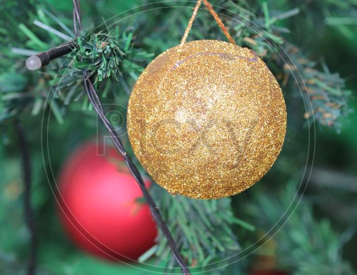 Christmas Balls with Yellow Colors with green leaves
