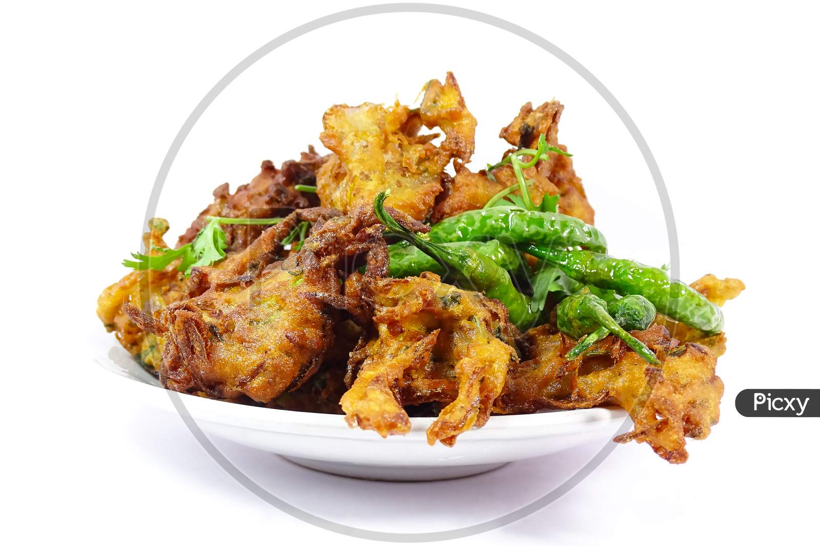 Fresh indian snack spicy onion fritters. pakoda. on white background
