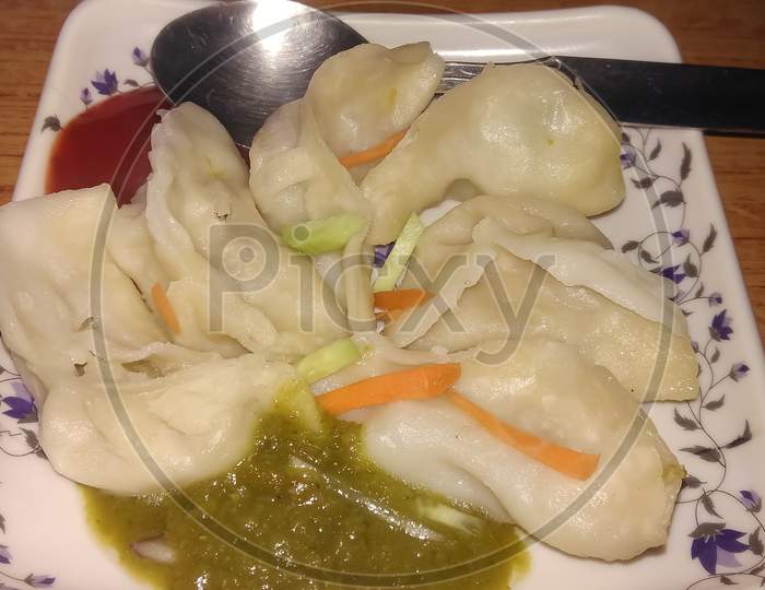 Veg momo served with tomato and chilli sauce