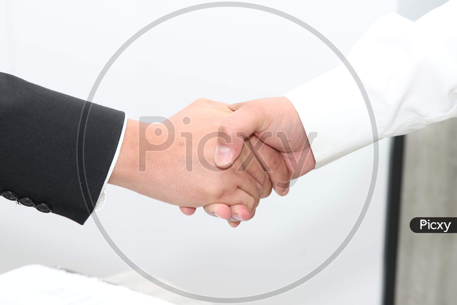 Handshake after signing the deal