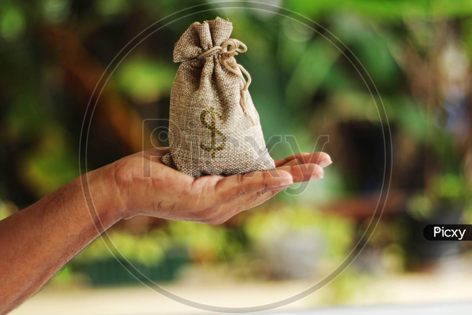 A View Of A Money Bag Stock Photo In Bokesh Background