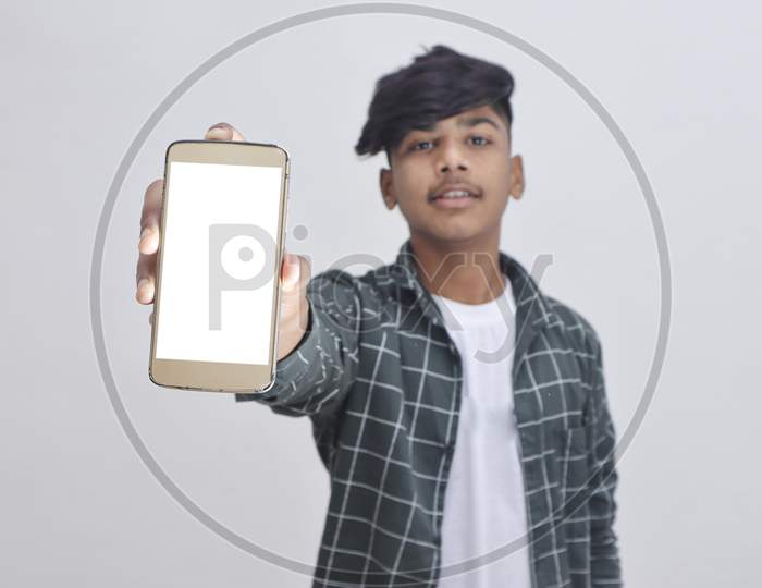 Indian College Student Showing Mobile Screen On White Background.