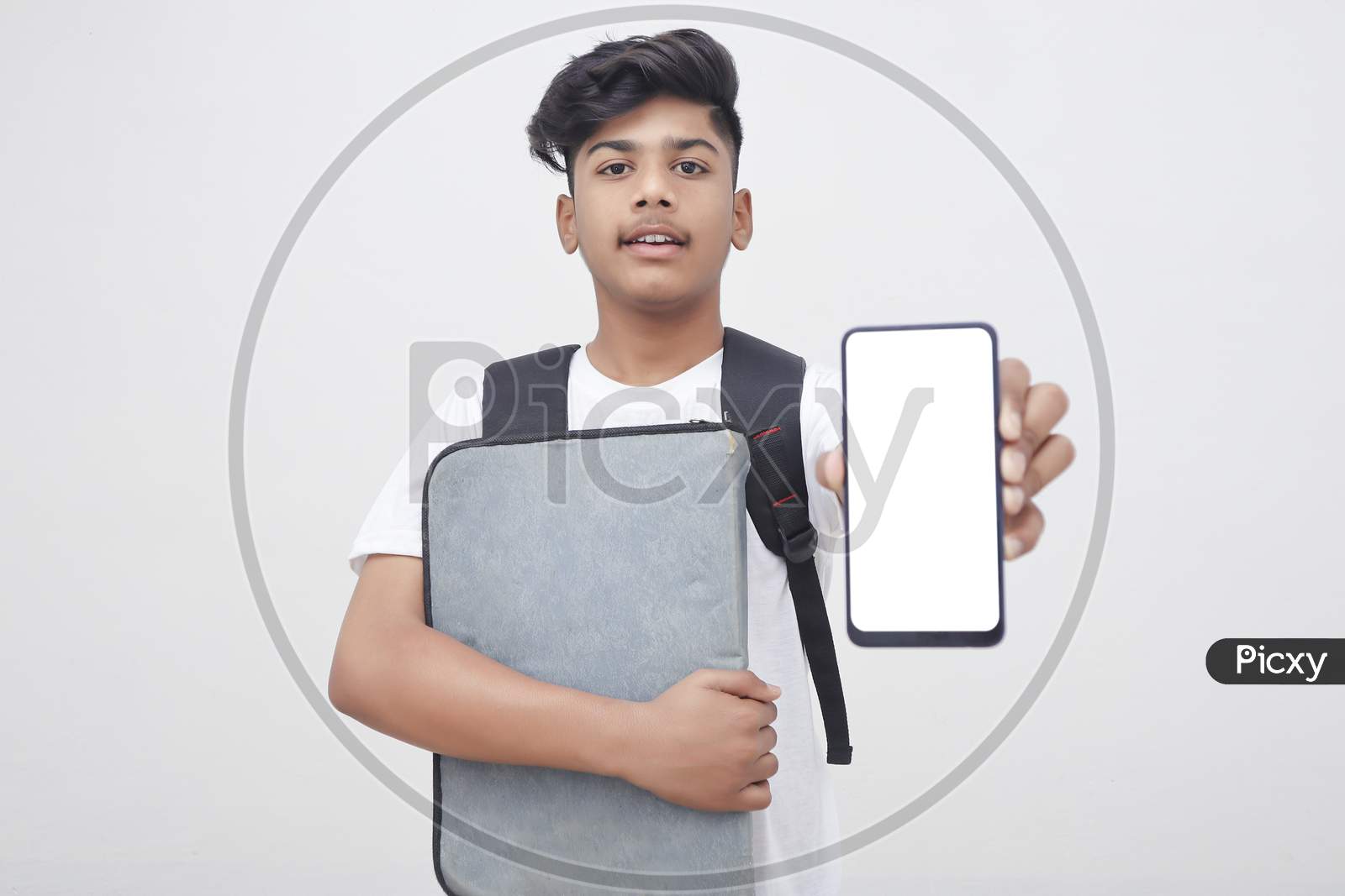 Young Indian Student Holding File And Showing Smartphone Screen On White Background.