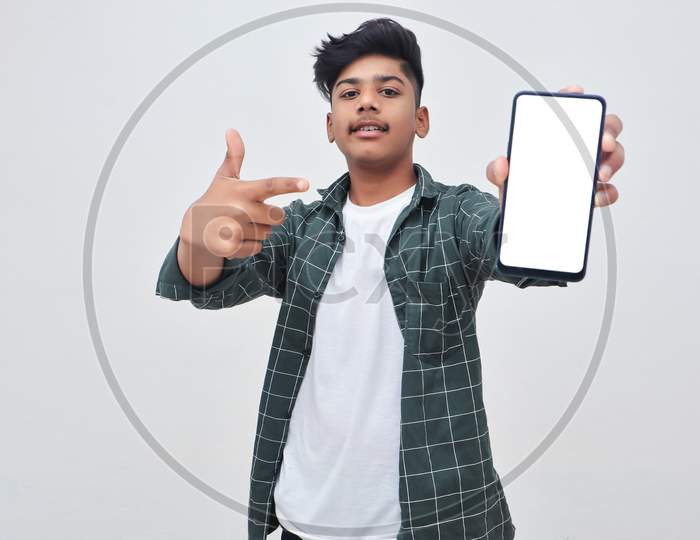 Young Indian Collage Boy Showing Smartphone Screen On White Background.