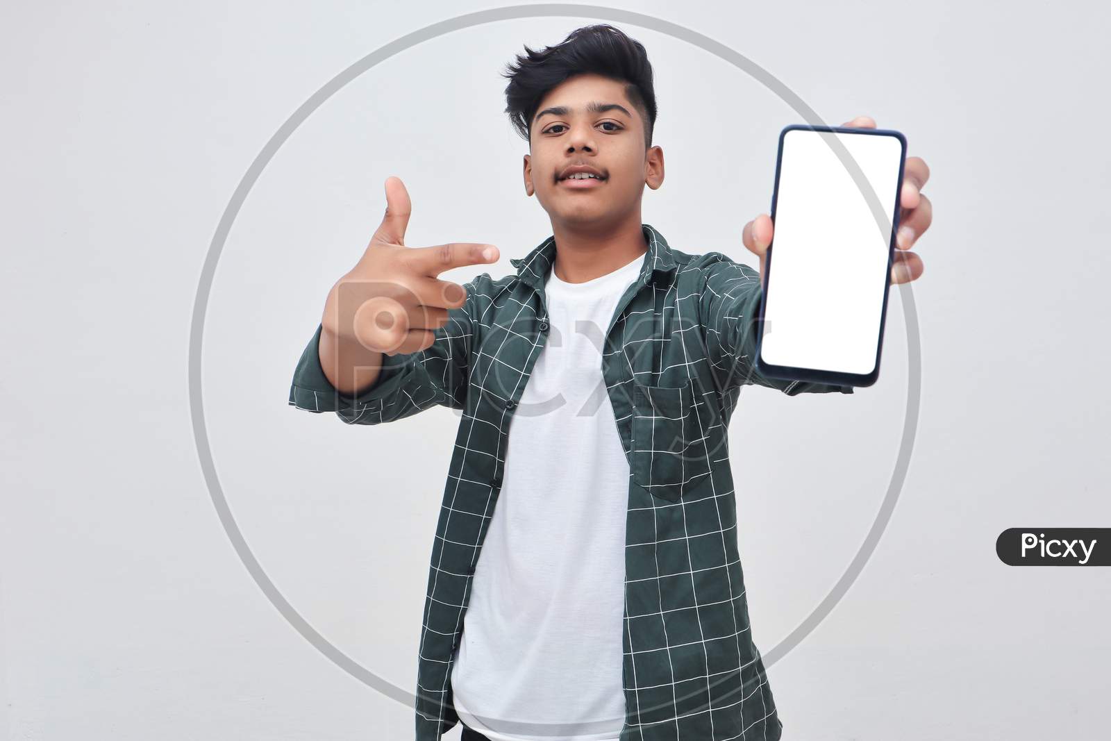 Young Indian Collage Boy Showing Smartphone Screen On White Background.
