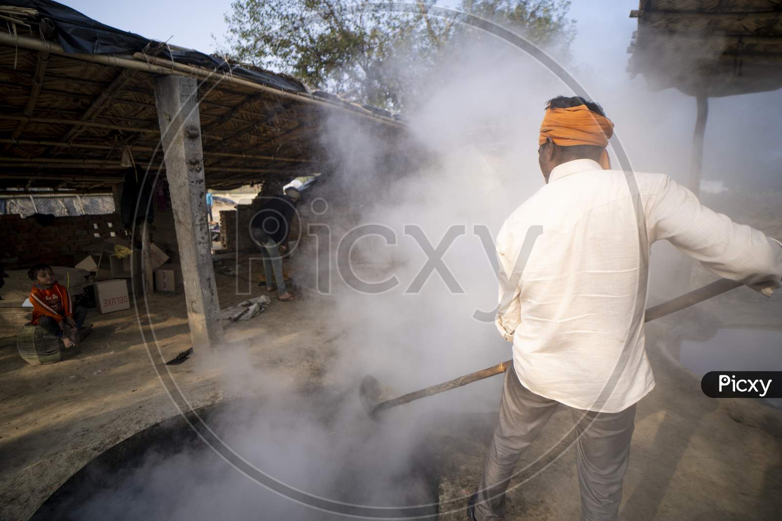 Delhi, India- January 12 2022- Indian Men Making Jaggery Out Of Sugarcane Juice In Uttar Pradesh. Men Working In Small Business In Villages.
