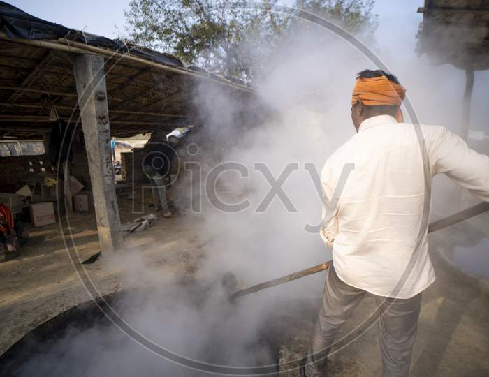 Delhi, India- January 12 2022- Indian Men Making Jaggery Out Of Sugarcane Juice In Uttar Pradesh. Men Working In Small Business In Villages.