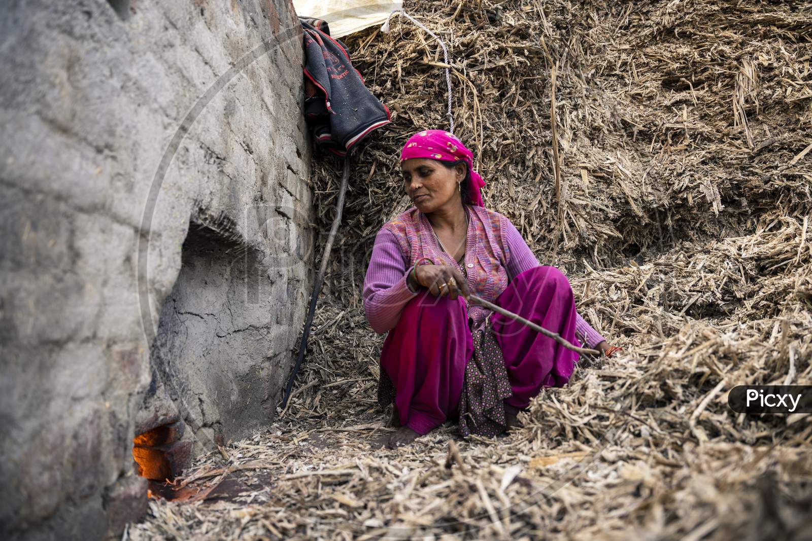 Moradabad, Uttar Pradesh- January 12 2022- Portrait Of A Village Woman Working In Jaggery Factory In Gad Mukteshwar.