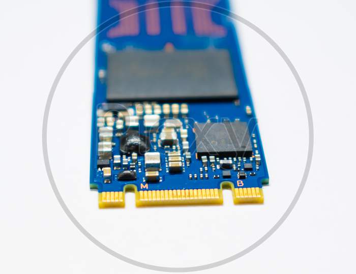 SSD hard drive NVMe version for slot M.2 laid on white background and narrow focus at pinout