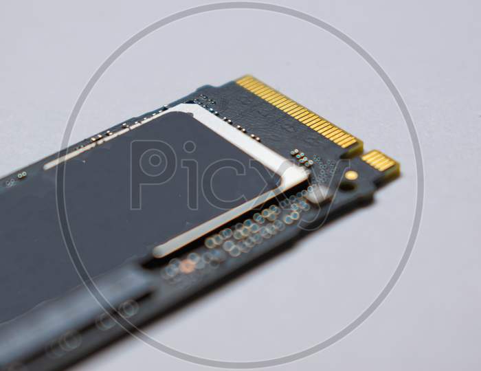 SSD hard drive NVMe version for slot M.2 laid on white background and narrow focus at pinout