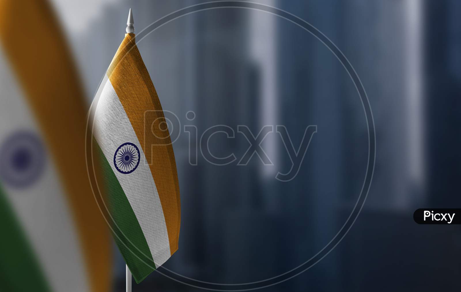 Small Flags Of India On A Blurry Background Of The City