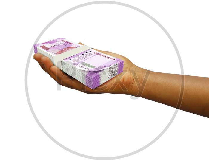 Hand Holding 3D rendered stack of Indian rupee notes isolated on white background