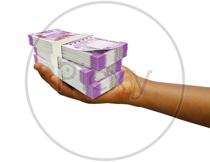 Hand Holding 3D rendering of 3 stacks of Indian rupee notes isolated on white background