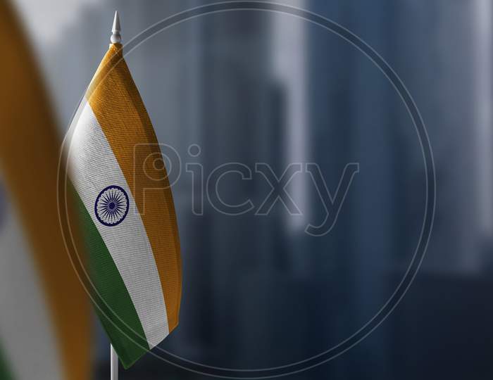 Small Flags Of India On A Blurry Background Of The City