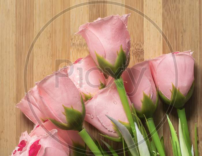 Valentine'S Day Background With A Bouquet Of Pink Roses On A Wooden Table.