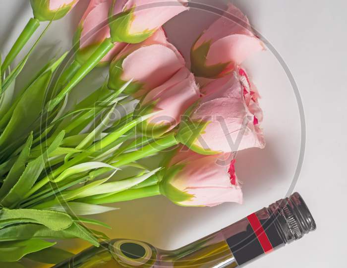 Valentine'S Day Background. Wine Bottle With Bouquet Of Pink Roses On Isolated White Background. Top View