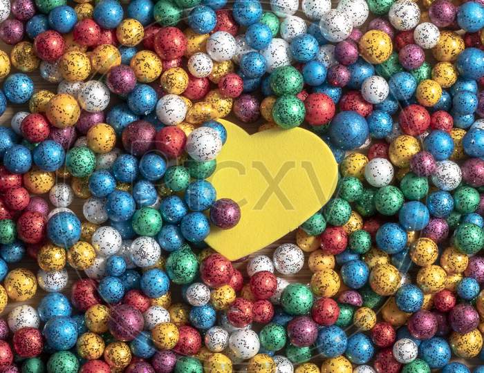 Valentine'S Day Background. Multicolor Small Size Thermocol Decorative Balls With Yellow Hearts On Top