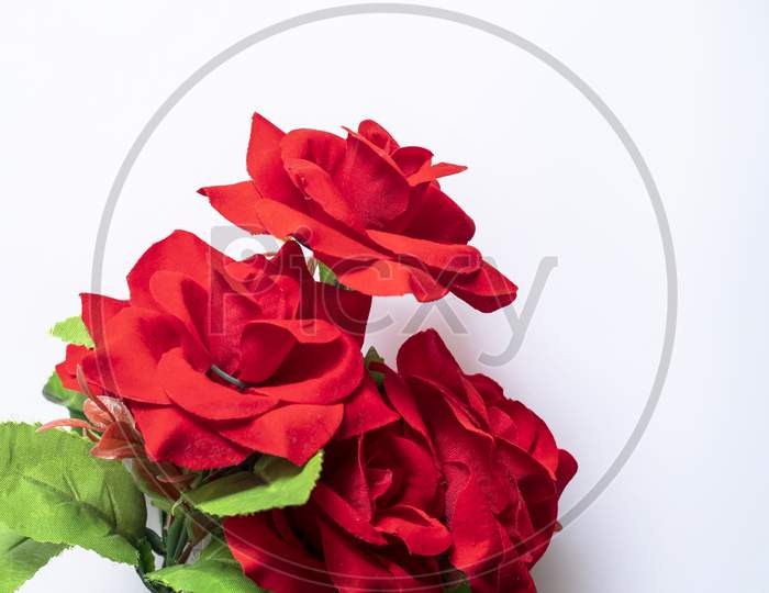 Bouquet Of Red Plastic Roses On A White Background.