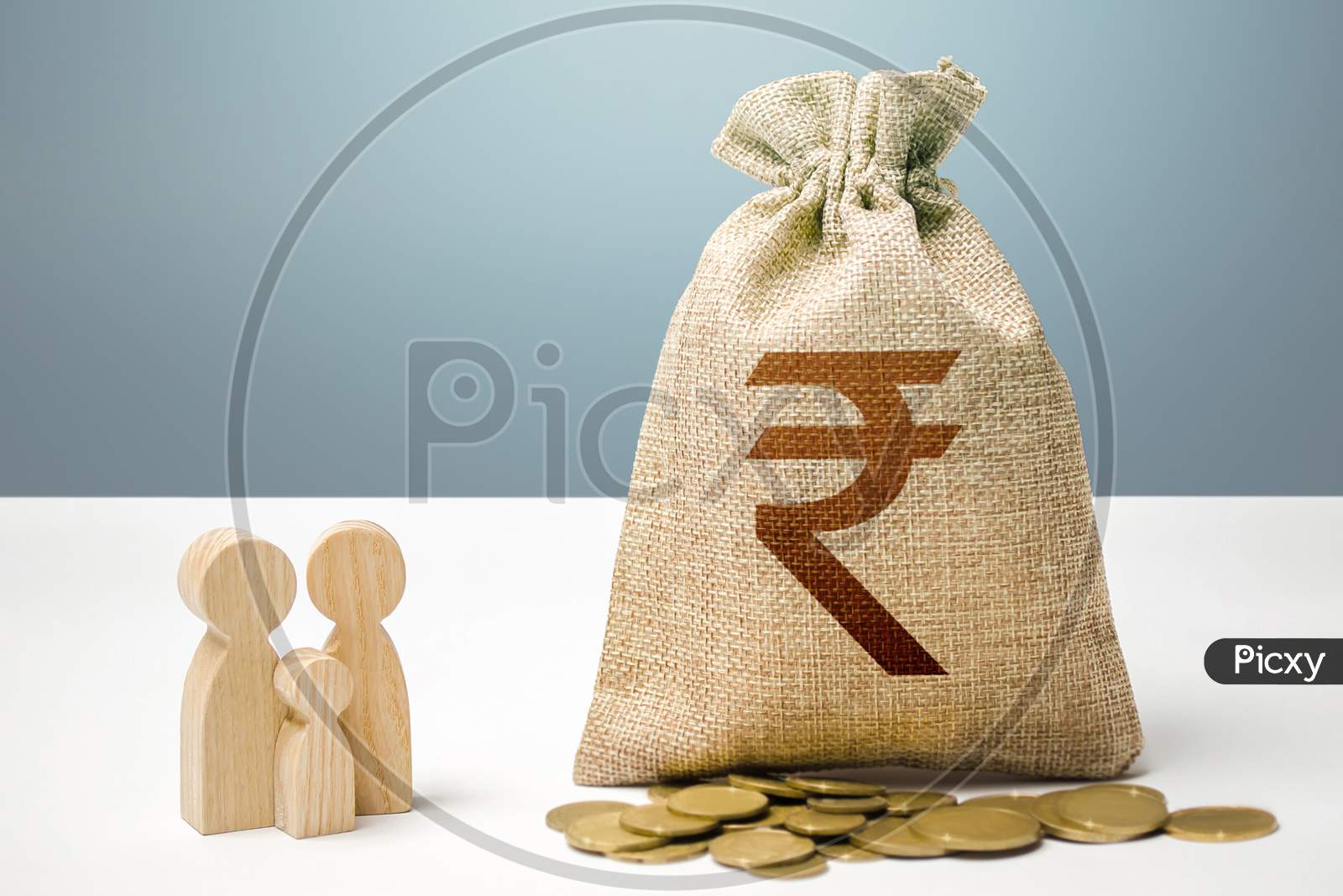 Indian Rupee Money Bag With Money And Family Figurines. Financial Support For Social Institutions. Providing Assistance To Citizens. Investments In Human Capital, Culture And Social Projects.