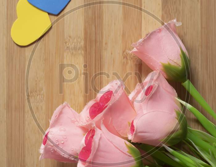 Valentine'S Day Backgrounds With A Bouquet Of Pink Roses And Little Hearts On A Wooden Table For The Concept Of Love.