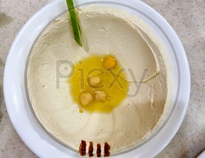 Hummus is a Middle Eastern dip, spread, or savory dish made from cooked, mashed chickpeas blended with tahini, lemon juice, and garlic.