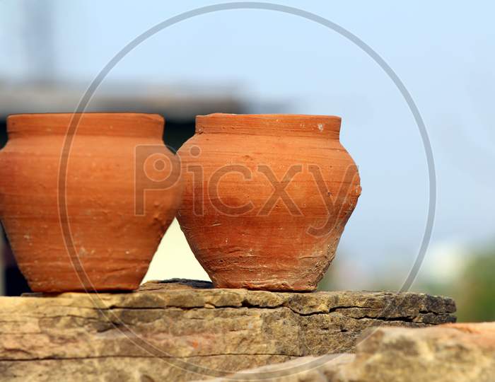 red clay pot put on a stone