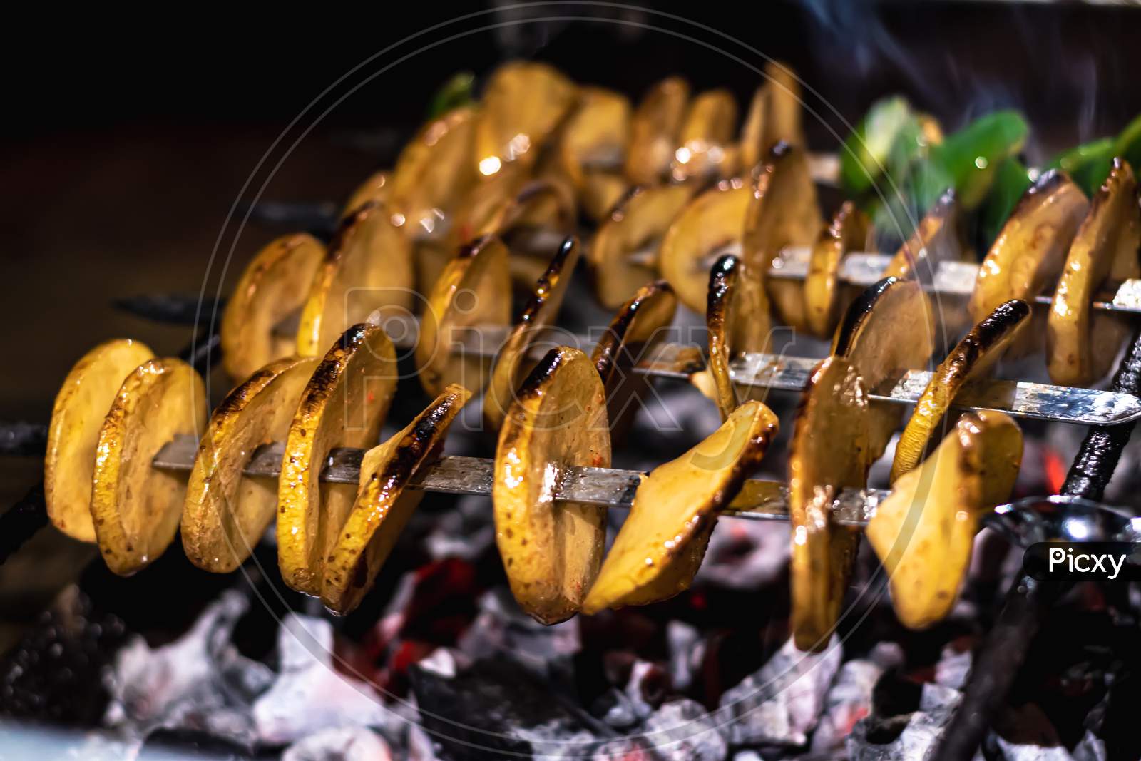 Delicious Vegetarian Skewers Made From Potatoes And Capsicum Over The Coals On A Barbecue