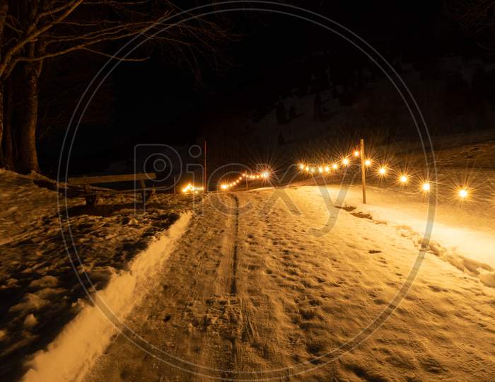 Saint Margrethenberg, Switzerland, December 19, 2021 Small Walkway Illuminated By The Lights
