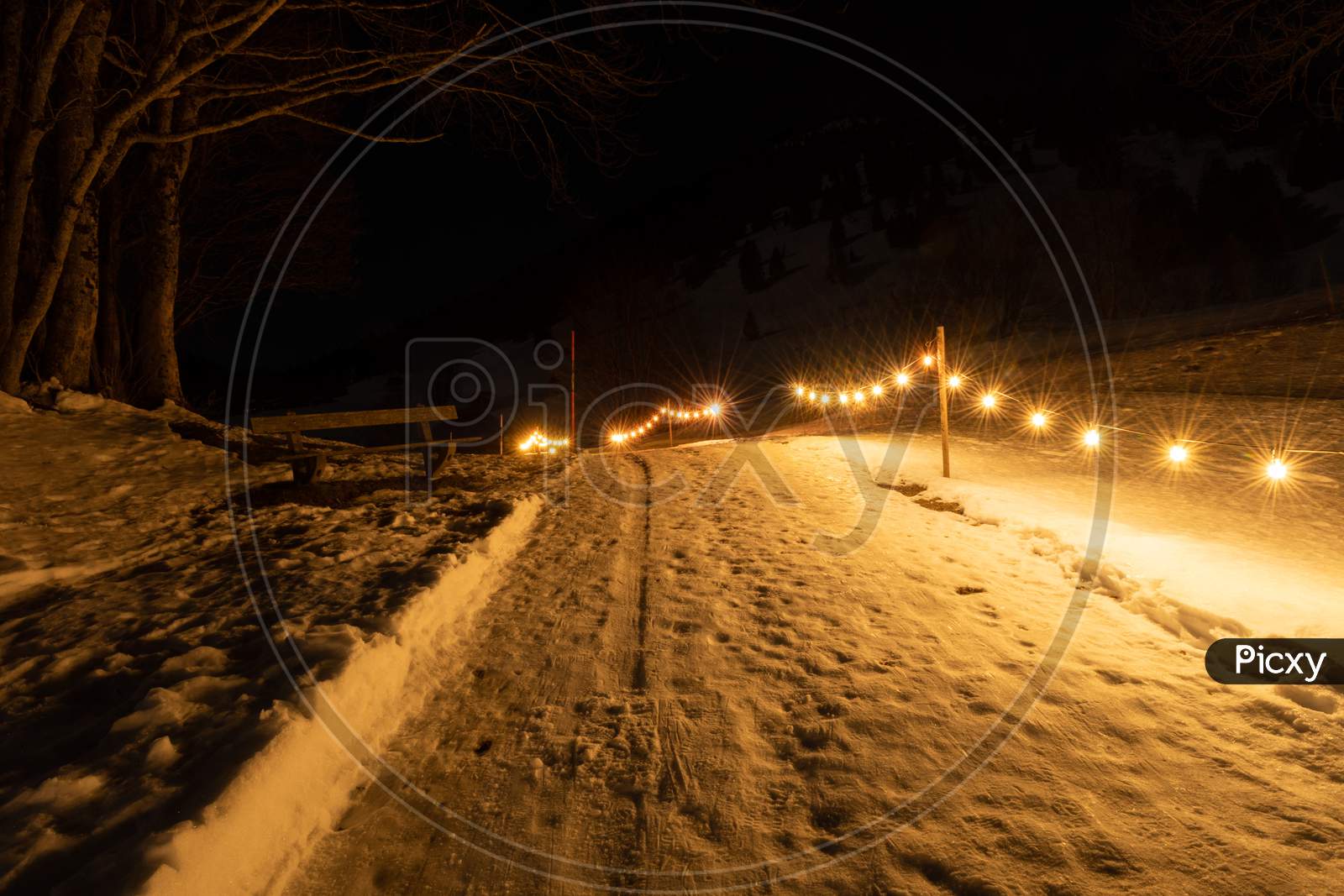 Saint Margrethenberg, Switzerland, December 19, 2021 Small Walkway Illuminated By The Lights