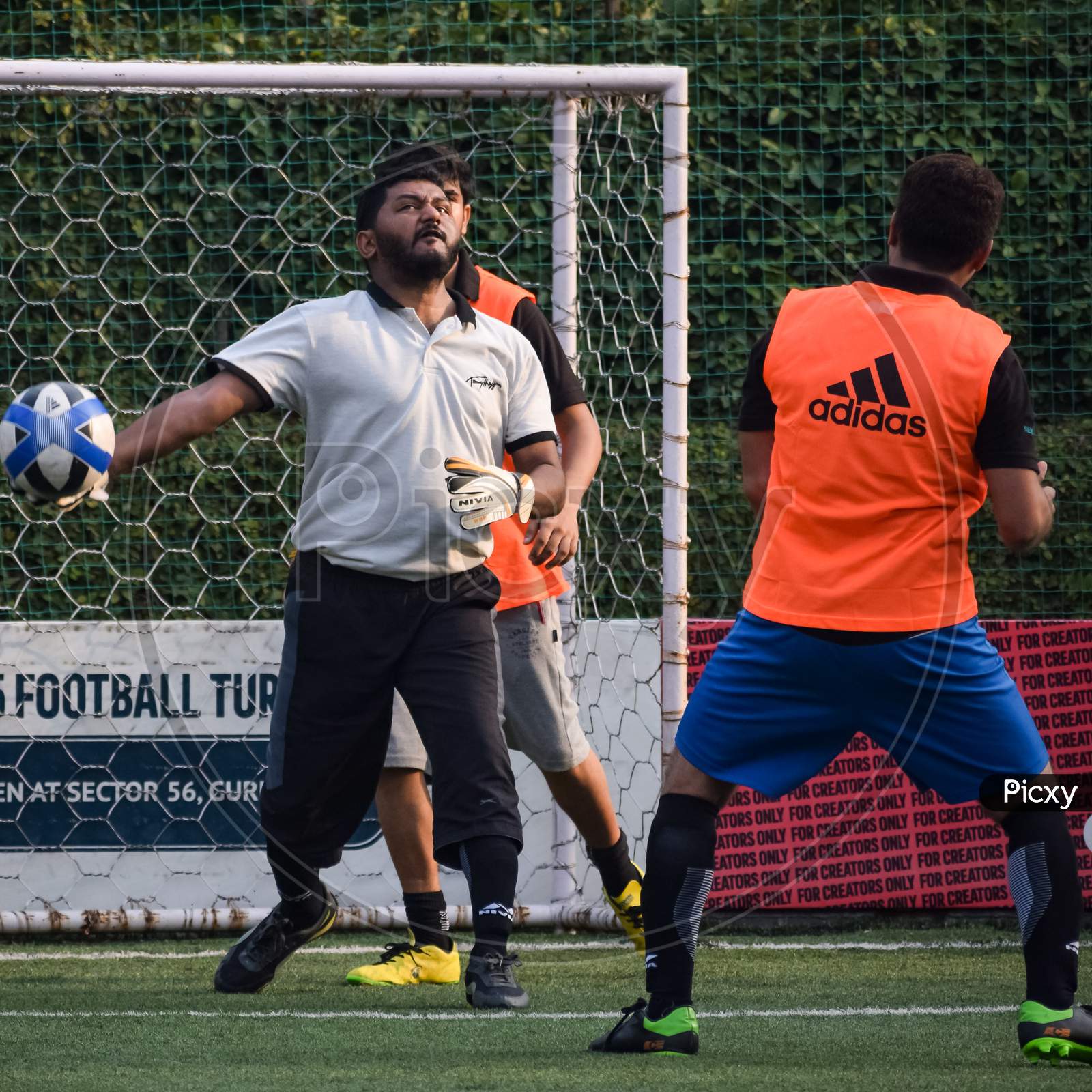 New Delhi, India - July 01 2018: Footballers Of Local Football Team During Game In Regional Derby Championship On A Bad Football Pitch. Hot Moment Of Football Match On Grass Green Field Of The Stadium