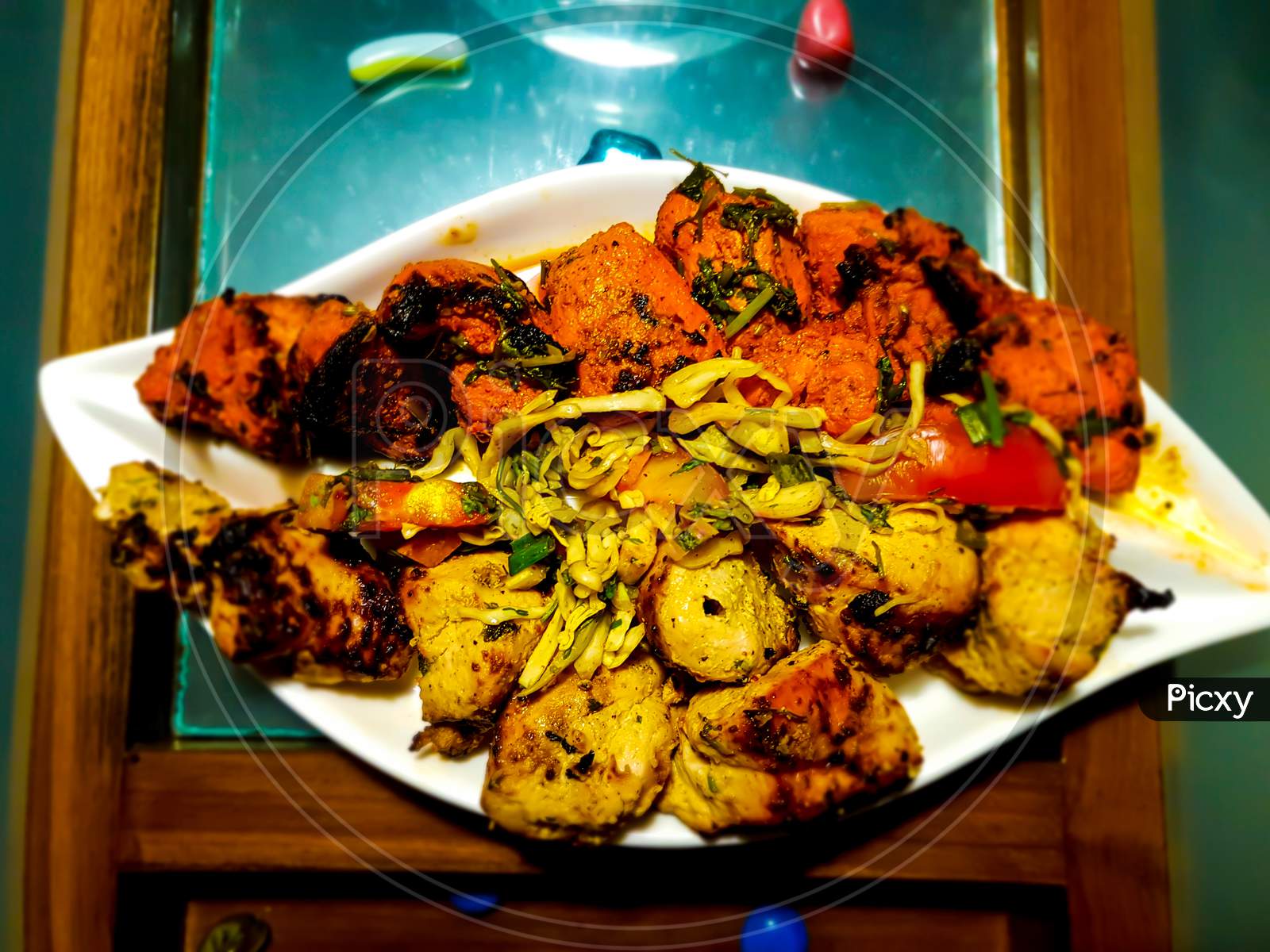 Delicious Grilled Tandoori Of Assorted Meats With Tomatoes And Cabbage