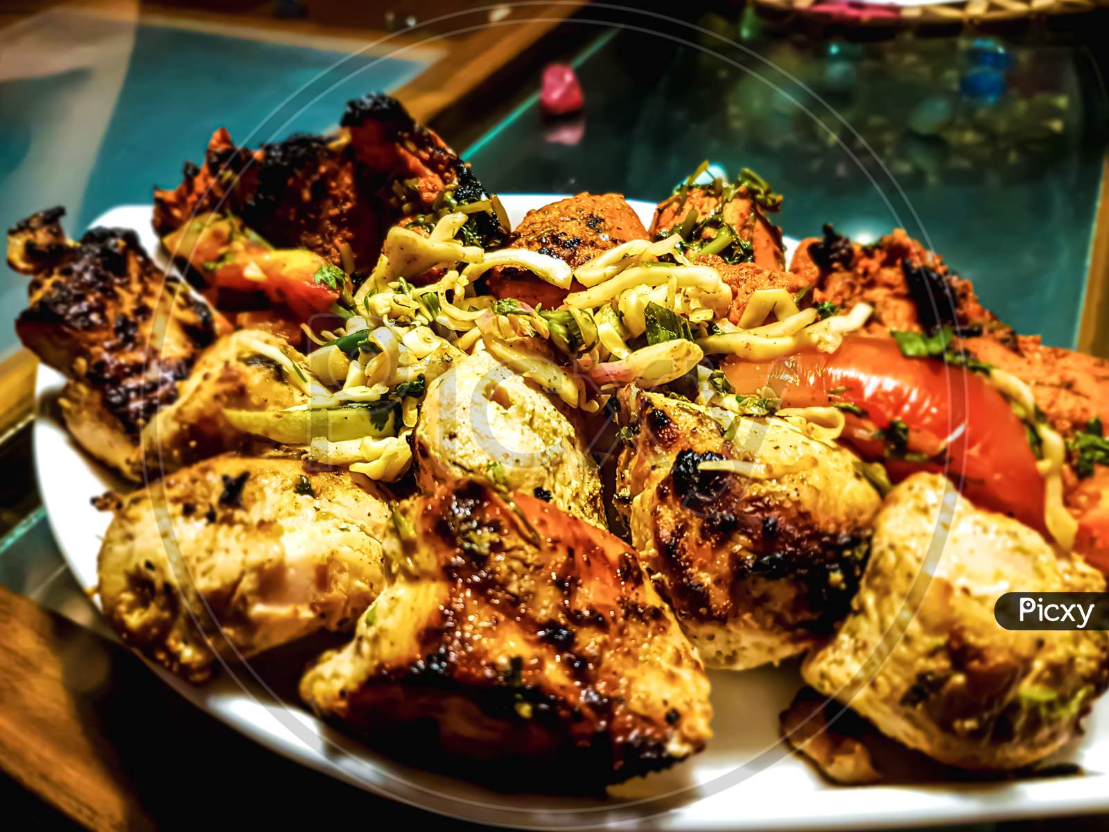 Delicious Grilled Tandoori Of Assorted Meats With Tomatoes And Cabbage