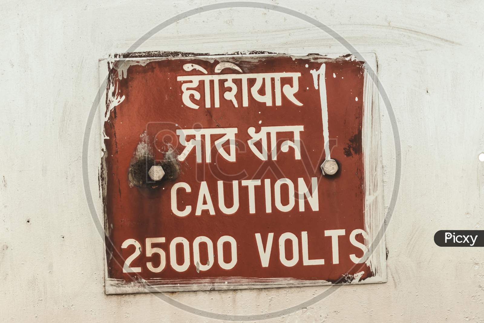 Caution 25000 High Voltage Safety Warning Sign In A Clear And Straight Instructions To Communicate At Work With Everyone For Spreading Awareness About A Potential Risk In Workplace Around The Premises. Written In Hindi And English Language.