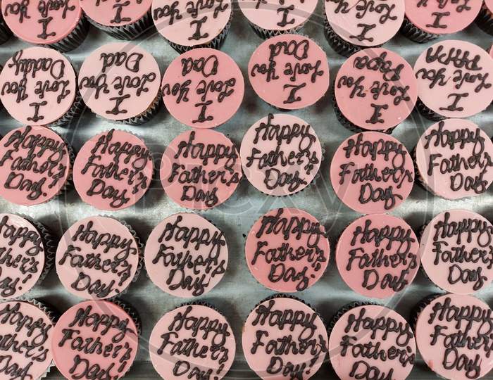 Happy Fathers Day Writing On A Pink Colour Chocolate Decoration On Top Of A Cupcake