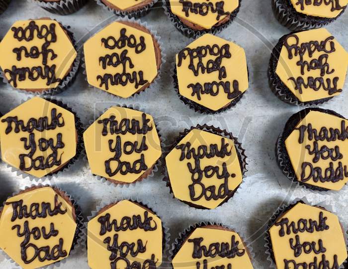 Thank You Dad Writing On A Yellow Colour Chocolate Decoration On Top Of A Cupcake