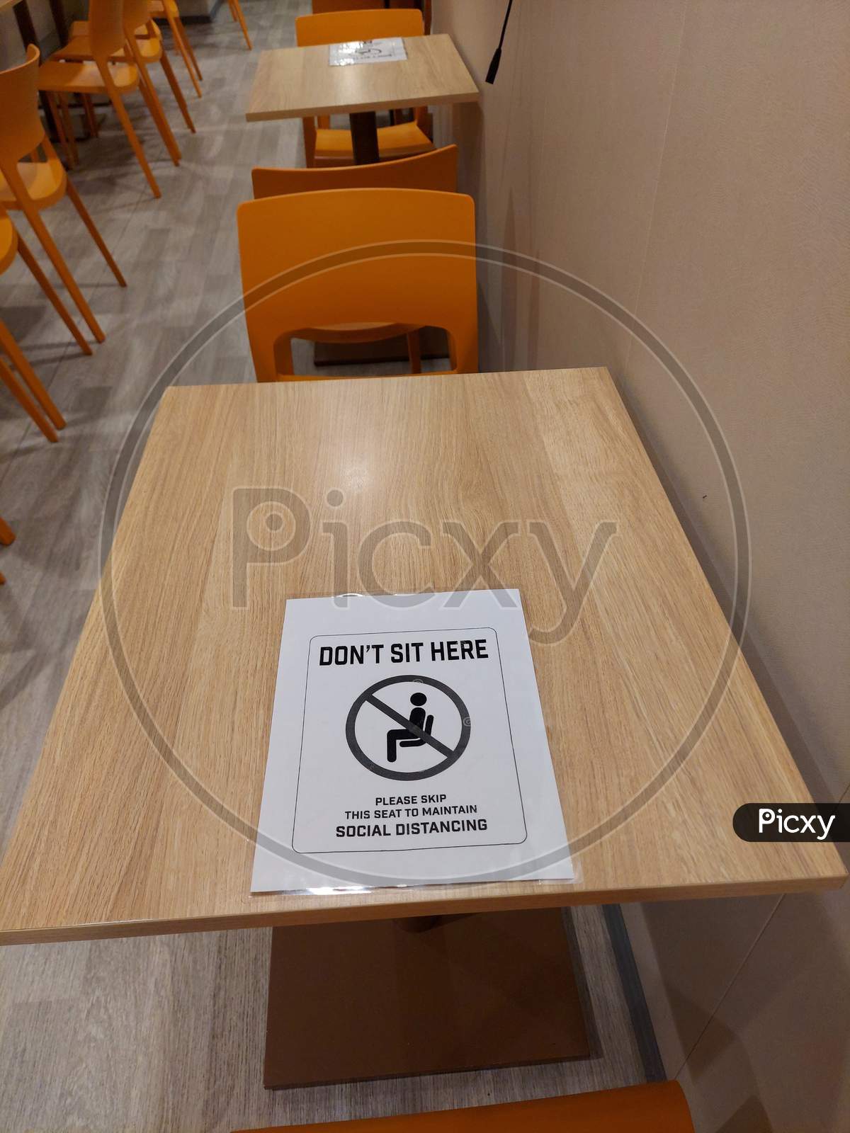 Do Not Sit Sign On A Table Due To Covid-19 To Ensure Social Distancing