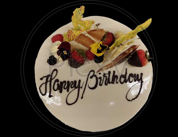 Celebration Cake With Happy Birthday Writing On It Isolated In Black Background