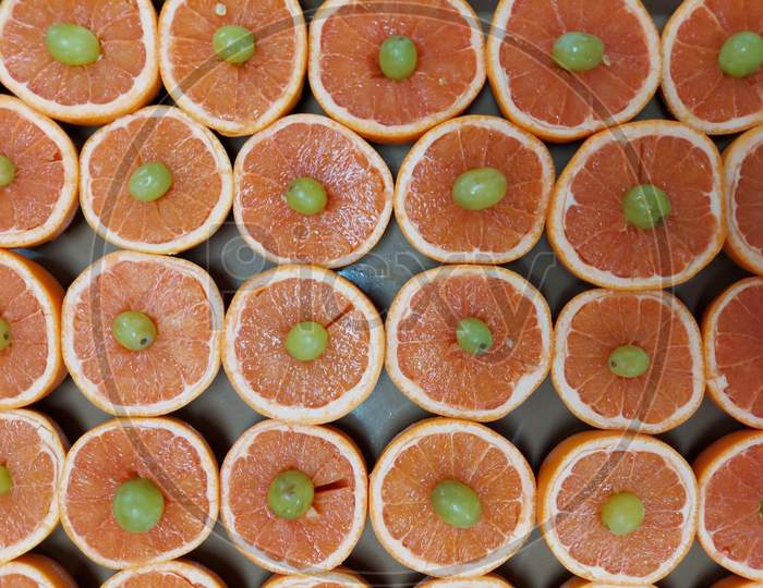 Sliced Grapefruit With Greps On Top
